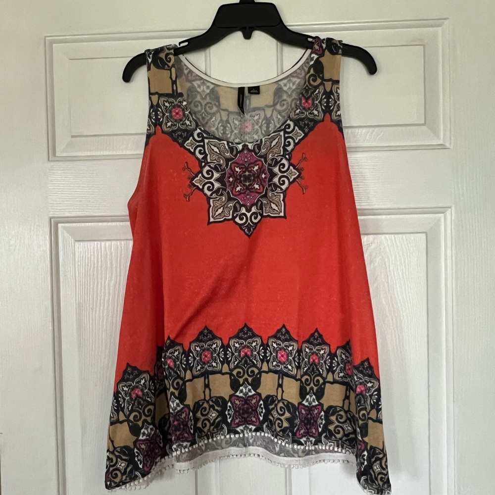 Orange, tan and navy print top with crochet trim.